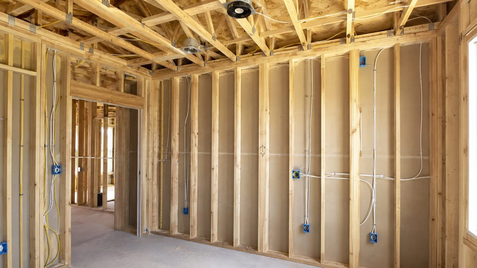 Clean wall rough-in with blue outlet boxes — C. Kennedy Electric